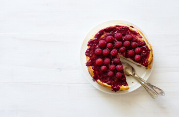 Homemade ricotta casserole with raspberries on white wooden background. Flat lay