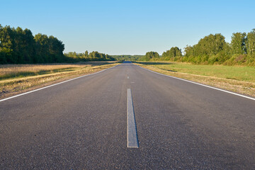 A road receding into the distance at sunset in central Russia