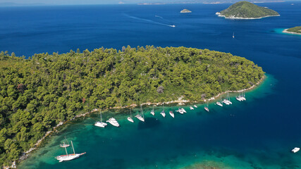 Aerial drone photo of safe small fjord harbour of Mplo near bay of Panormos a popular yacht and...