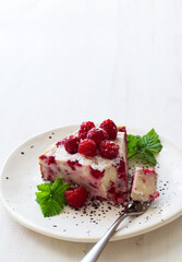 Piece of homemade ricotta and raspberries casserole closeup