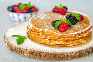 Crepes decorated with raspberries and blackberries close-up