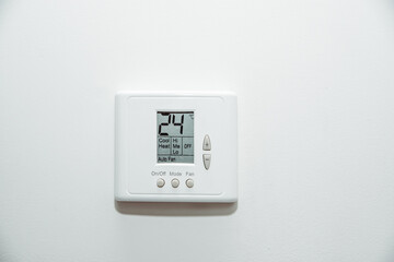 Air conditioner in the room. The concept of cooling the apartment on warm days. White panel for temperature control in a room, office.