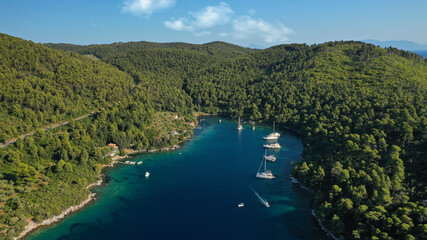 Aerial drone photo of safe small fjord harbour of Mplo near bay of Panormos a popular yacht and...