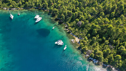 Aerial drone photo of safe small fjord harbour of Mplo near bay of Panormos a popular yacht and...