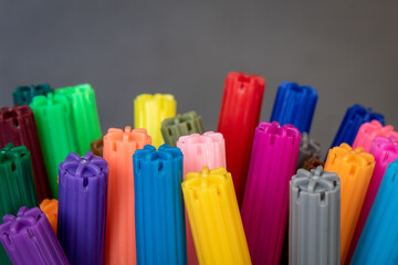 Abstract macro photography of multi-colored felt tip pens showing caps detail. Empty space for text