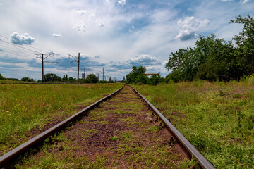 Fototapeta na wymiar Ukraine, Krivoy Rog, the 16 of July 2020. Rarely used rail tracks near the town park.