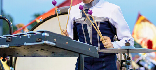 Musician Performing on the field with marching bells. Percussion section performing with other...