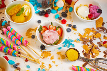 Strawberry ice cream, mango ice cream with lollipop and candy's.