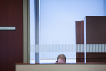 Businessman seen through glass in office