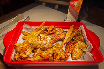 spicy fish fry in a red plate  