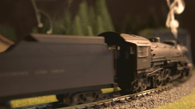 Model of vintage steam locomotive entering the tunnel. Rail transport modeling in Europe.