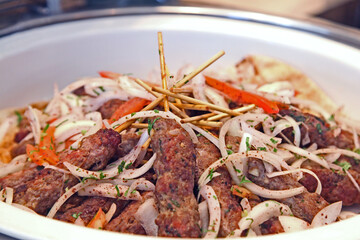 Lamb kofta with onion and tomatos