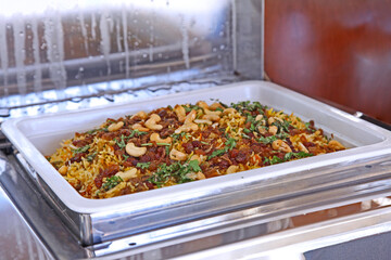 chicken biryani in a restaurant buffet.
