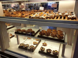 KUALA LUMPUR, MALAYSIA -JULY 17, 2020: Various types of breads are displayed for sale inside the bakery display rack. Made in various designs to provide variations to customers.