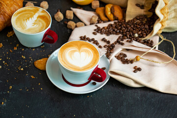 Cappuccino white cup with coffee beans, muffin, croissant, cookies and grapefruit.