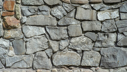 The texture of the old wall from the stones as background.