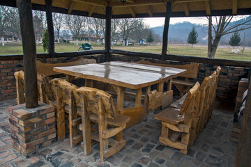 Wooden benches and tables in the outdoor restaurant