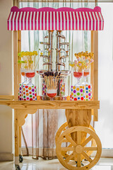 Chocolate fountain with in a wooden trolley 