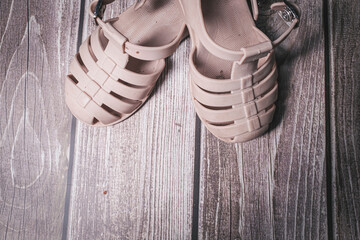 Rubber Brown baby girl sandals shoes on a wooden floor