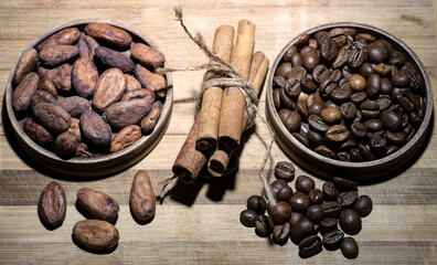 coffee beans, cocoa beans, and cinnamon sticks on wooden background