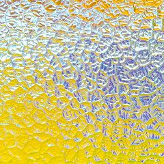 Abstract background: yellow, blue and white light effect on antique textured pane of glass
