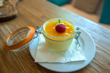 Mango pudding with a raspberry 