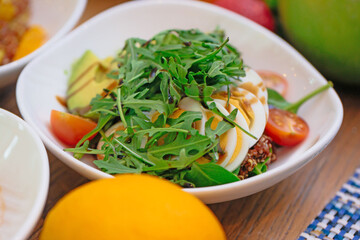 Avocado, egg and cherry tomato salad for healthy breakfast 