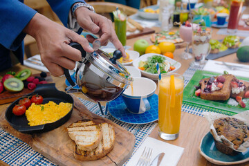 Tea pouring in cup for breakfast 