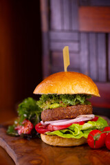 A beyond delicious plant based non meat burger with lettuce, onion, tomato and vegan buns.