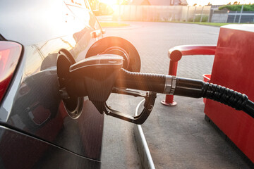 Refueling car. Pump gas at petrol fuel station. Gasoline oil nozzle tank from hand person. Automotive industry or transportation concept.