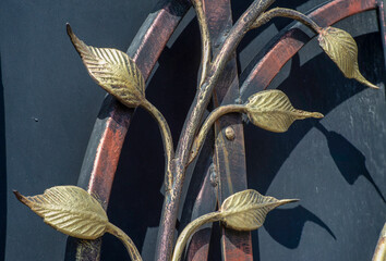 old and modern decorative forged metal elements of fences, gates, window gratings