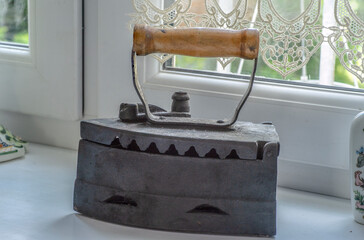 old irons made of cast-iron with a wooden handle