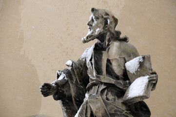 Statue near Latin Cathedral under snow in Lviv, Ukraine