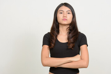 Fototapeta premium Portrait of young beautiful Asian woman looking at camera