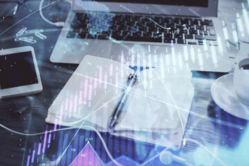 Multi exposure of financial graph drawings and desk with open notebook background. Concept of forex