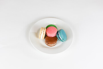 Colorful macarons on white plate