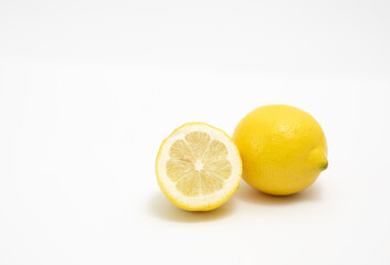 A Full Juicy Lemon And A Half On A White Background