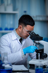 scientist working with microscope in laboratory, medical science research