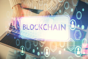 Double exposure of woman hands working on computer and blockchain theme hologram drawing. Top View. bitcoin cryptocurrency concept.