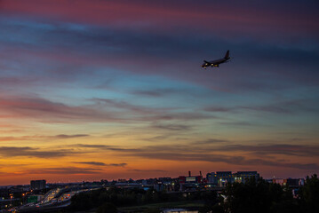 A plane arriving during the
 sunset