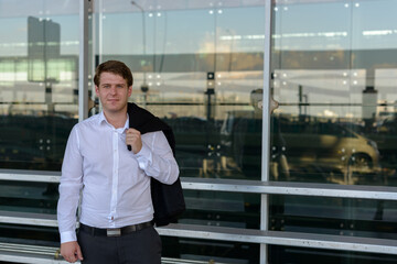 Portrait of young handsome businessman at the airport