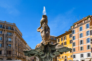 Fototapeta na wymiar The Triton Fountain in the Piazza Barberini, Rome Italy, representing Triton, half-man and half-fish, blowing his horn to calm the waters