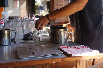 the barista is making coffee in the kitchen