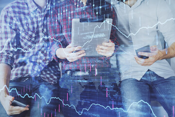 Double exposure of forex graph drawing and man and woman working together holding and using a mobile device. Trade concept.