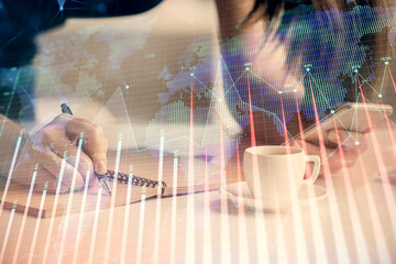 Double exposure of forex graph sketch hologram and woman holding and using a mobile device. Stock market concept.