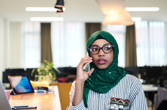 african muslim business woman using mobile phone