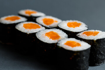 Japanese food. Rolls with red fish, fresh rice with salmon wrapped in nori.