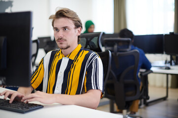 casual business man working on desktop computer