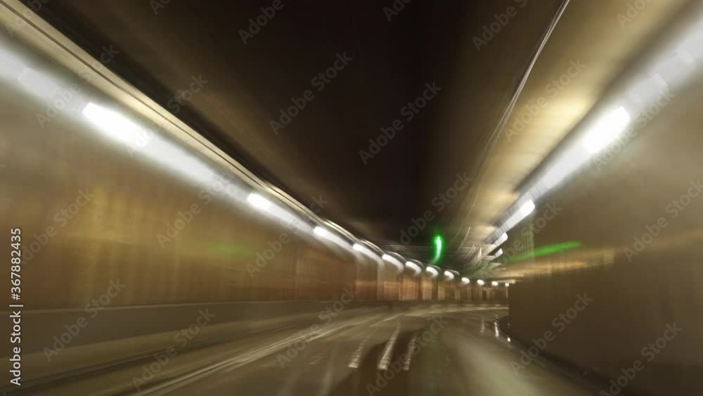 Poster blurry view of a tunnel with many lights.