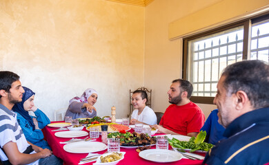 Happy arabic muslim family eating together in a family meeting 